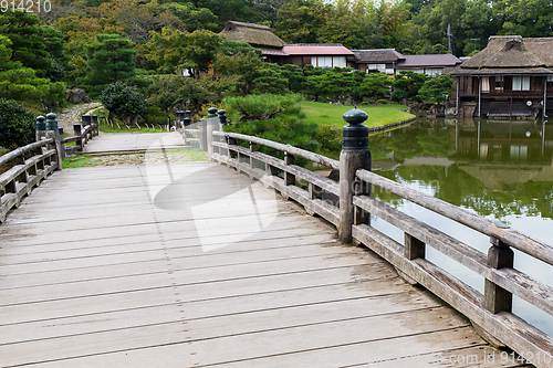 Image of Japanese garden with wooden bridge