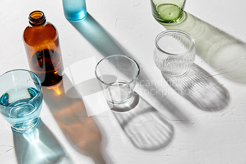 Image of glassware dropping shadows on white surface