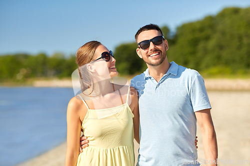 Image of happy couple hugging on summer beach