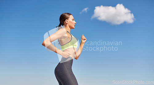 Image of young woman running at seaside