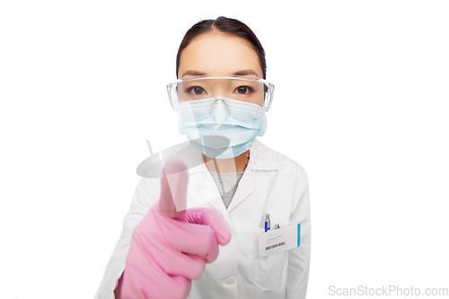 Image of asian female doctor in mask, goggles and gloves