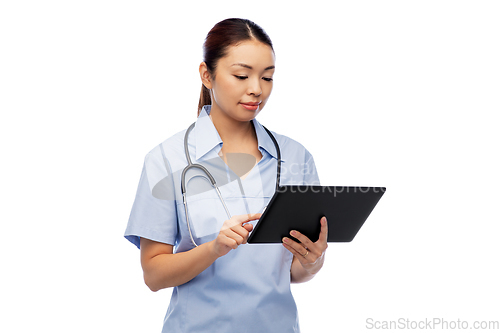 Image of asian female nurse with tablet pc and stethoscope