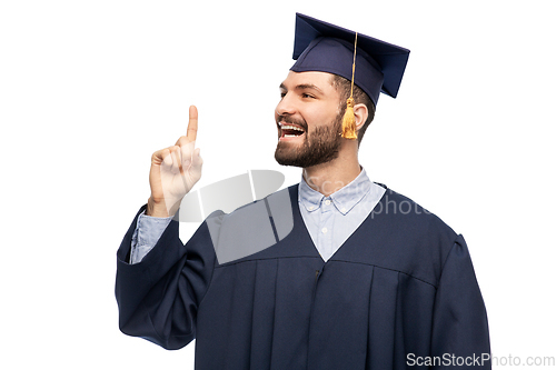 Image of happy graduate student pointing his finger up