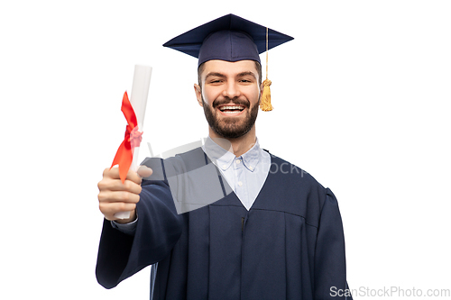 Image of male graduate student in mortar board with diploma