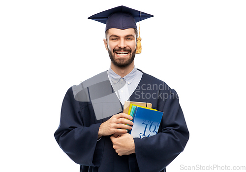 Image of happy graduate student or bachelor with books