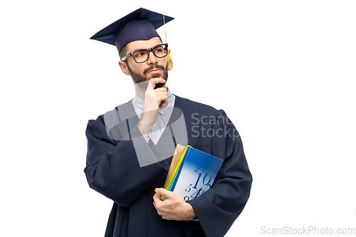 Image of thoughtful graduate student or bachelor with books