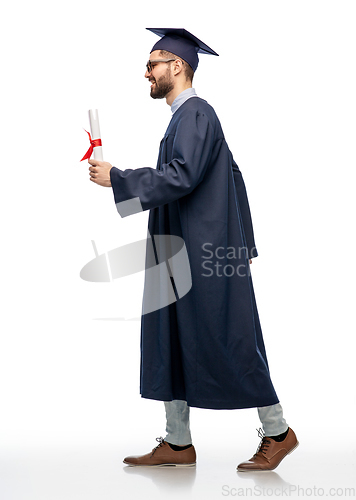 Image of male graduate student in mortar board with diploma