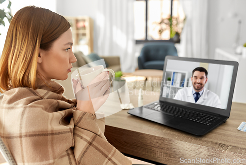 Image of sick woman having video call with doctor at home