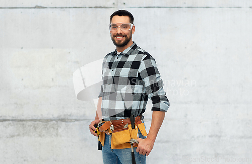 Image of happy male worker or builder with tool belt