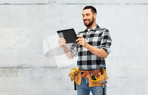 Image of happy builder with tablet computer and tools