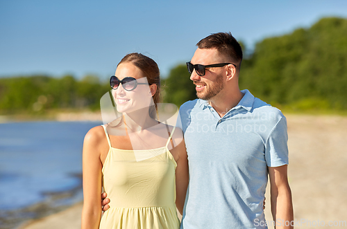 Image of happy couple hugging on summer beach