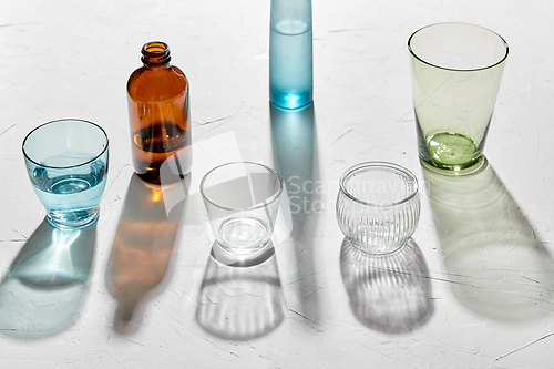 Image of glassware dropping shadows on white surface