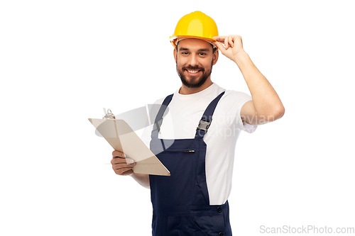 Image of male worker or builder in helmet with clipboard