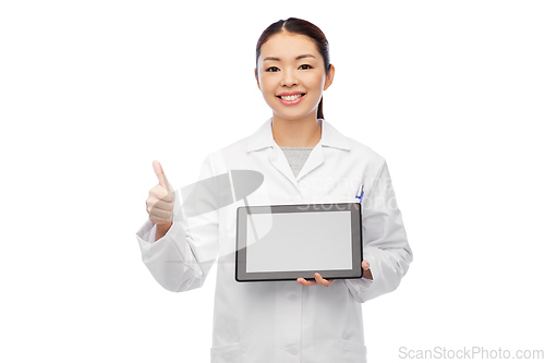 Image of asian female doctor with tablet pc shows thumbs up