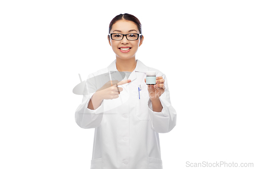 Image of smiling asian female doctor or nurse with medicine