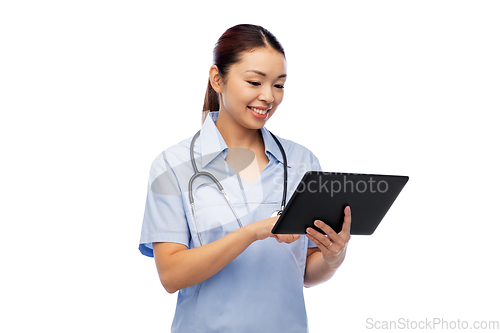 Image of asian female nurse with tablet pc and stethoscope