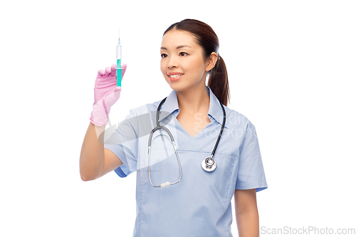 Image of happy asian female nurse with medicine and syringe