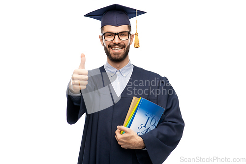 Image of happy male graduate student showing thumbs up