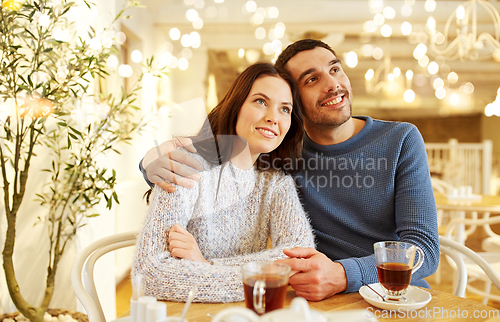 Image of happy couple drinking tea at restaurant