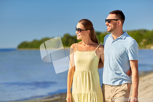 Image of happy couple hugging on summer beach