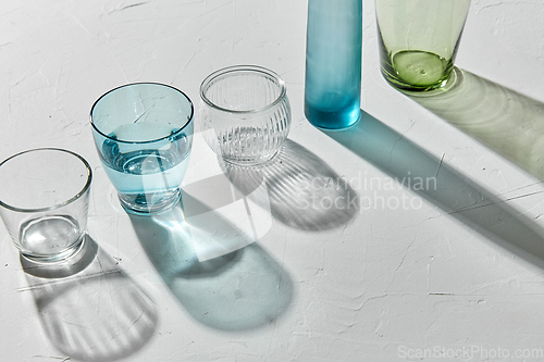 Image of glassware dropping shadows on white surface