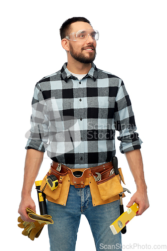 Image of happy male worker or builder with tools and level