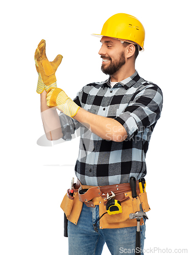 Image of happy male worker or builder in helmet and gloves