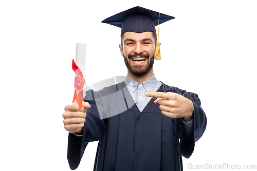 Image of male graduate student in mortar board with diploma