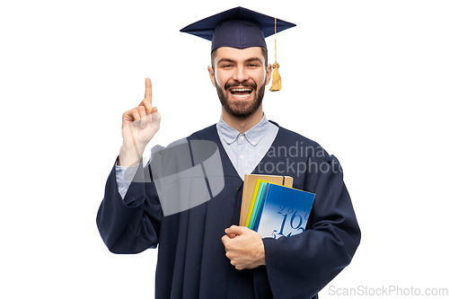 Image of happy graduate student pointing his finger up