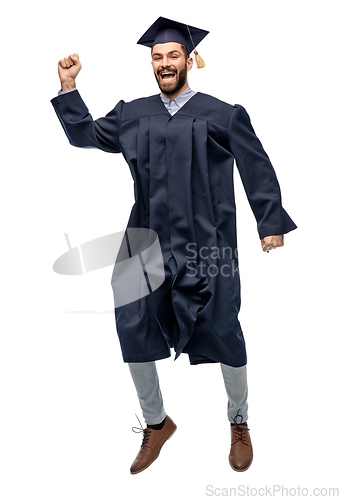 Image of happy male indian graduate student jumping