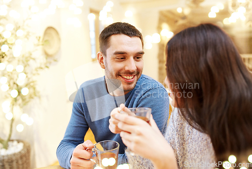 Image of happy couple drinking tea at cafe