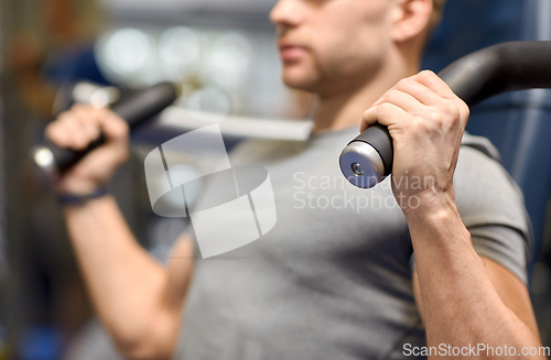 Image of smiling man exercising in gym