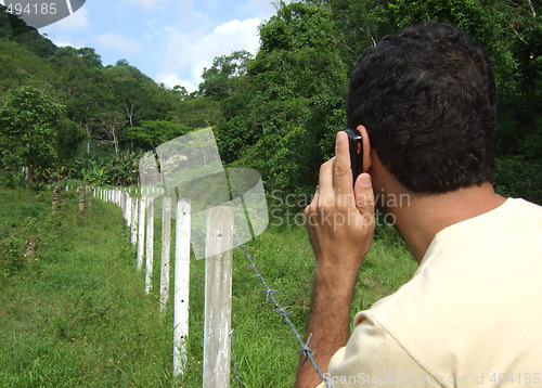 Image of Using a mobile phone in the forest