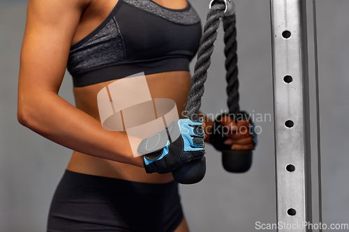Image of close up of woman exercising with bar in gym