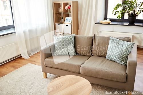 Image of sofa with cushions at cozy home living room