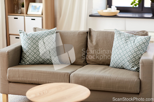 Image of sofa with cushions at cozy home living room