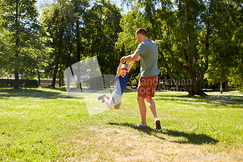 Image of happy father with son playing in summer park