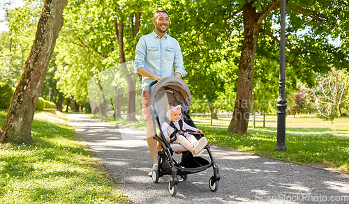 Image of happy father with child in stroller at summer park