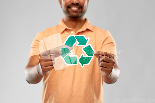 Image of smiling indian man holding green recycling sign