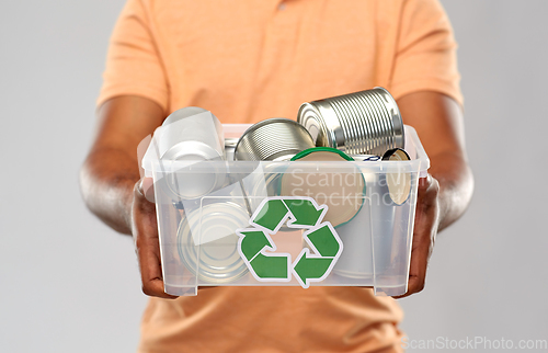 Image of close up of young man sorting metallic waste