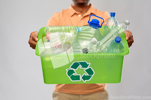 Image of close up of young man sorting plastic waste