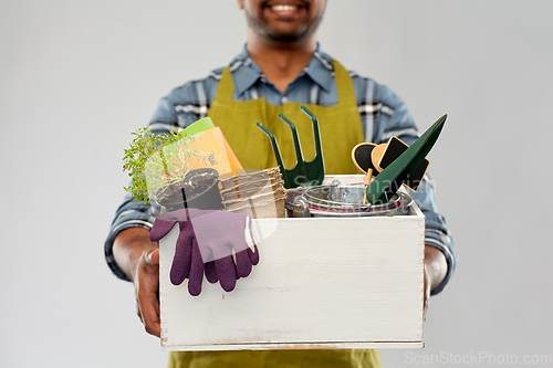 Image of indian gardener or farmer with box of garden tools