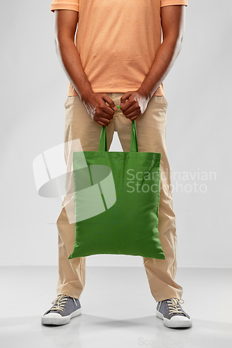 Image of man with reusable canvas bag for food shopping