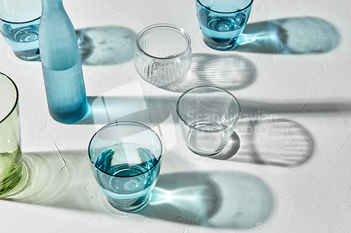 Image of glassware dropping shadows on white surface