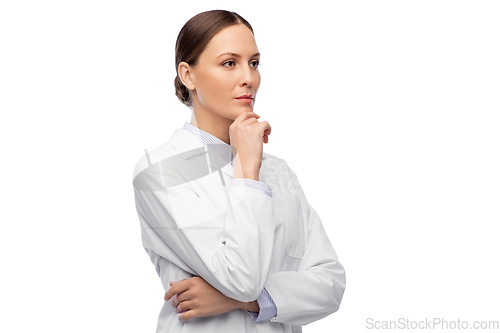 Image of thinking female doctor in white coat