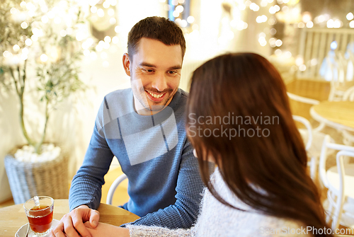 Image of happy couple drinking tea at cafe