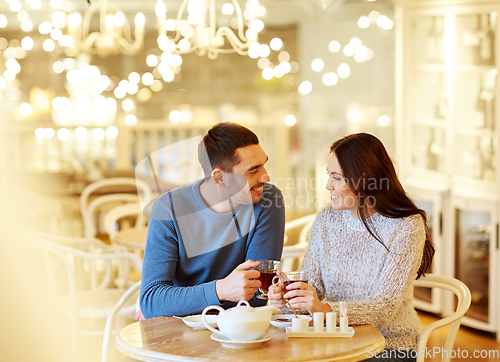 Image of happy couple drinking tea at cafe