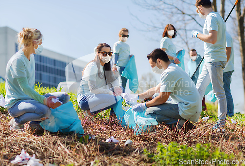 Image of volunteers with garbage bags cleaning park area