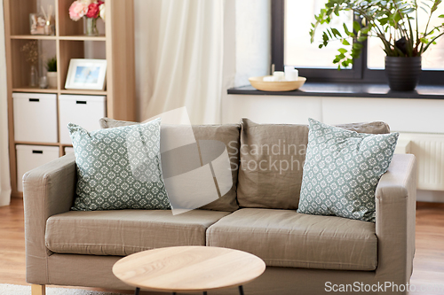 Image of sofa with cushions at cozy home living room