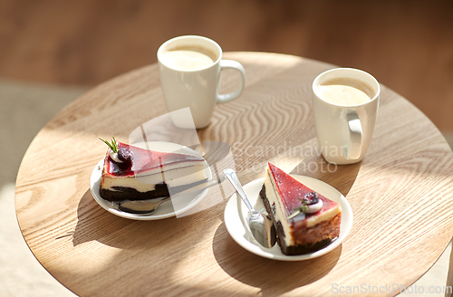 Image of pieces of chocolate cake on wooden table